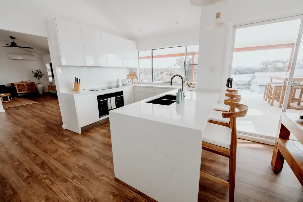 Bright open-plan kitchen presented to a polished cleaning standard